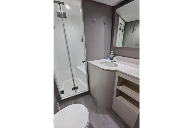 Serenity Now Yacht Photos Pics Modern bathroom in 2024 Ocean Alexander 35 Revolution yacht, featuring shower and sleek vanity.