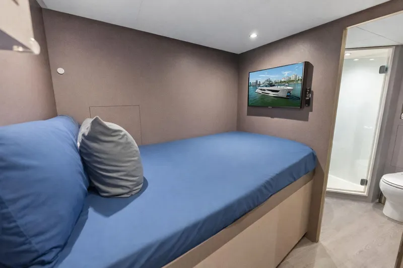 Serenity Now Yacht Photos Pics 2024 Ocean Alexander 35 Revolution yacht cabin with bed, TV, and ensuite bathroom.