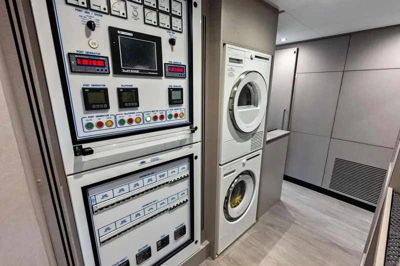 Serenity Now Yacht Photos Pics 2024 Ocean Alexander 35 Revolution yacht interior with control panel and laundry appliances.