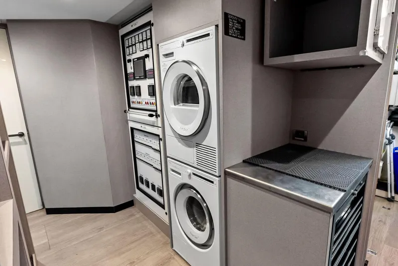 Serenity Now Yacht Photos Pics Laundry area with stacked washer and dryer in 2024 Ocean Alexander 35 Revolution yacht.
