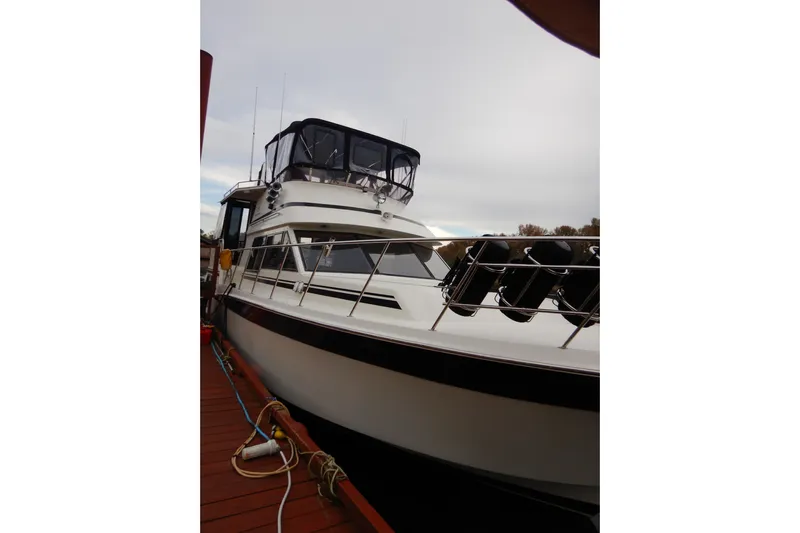 Alaska Sea Duction Yacht Photos Pics 1988 Camargue 48 Cockpit Motor Yacht docked, showcasing sleek design and spacious deck.