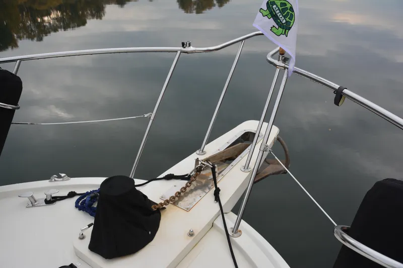 Alaska Sea Duction Yacht Photos Pics Bow of 1988 Camargue 48 Cockpit Motor Yacht with anchor chain and flag.