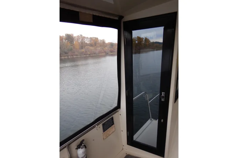 Alaska Sea Duction Yacht Photos Pics 1988 Camargue 48 Cockpit Motor Yacht interior view with river scenery.