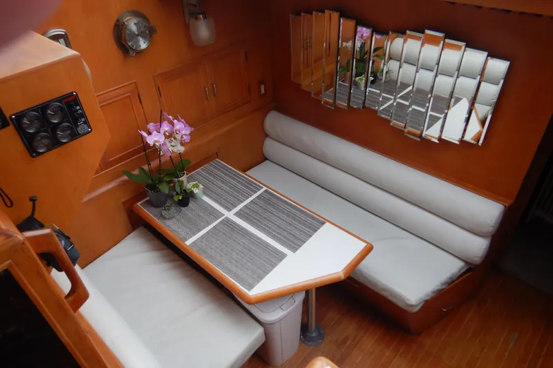 Alaska Sea Duction Yacht Photos Pics Interior of 1988 Camargue 48 Cockpit Motor Yacht with dining area and mirrored wall.