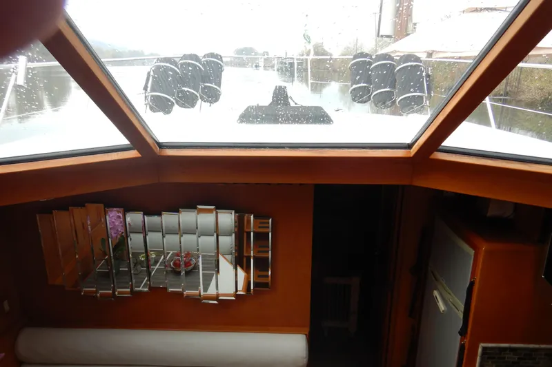 Alaska Sea Duction Yacht Photos Pics Interior view of 1988 Camargue 48 Cockpit Motor Yacht with mirrored decor and skylight.