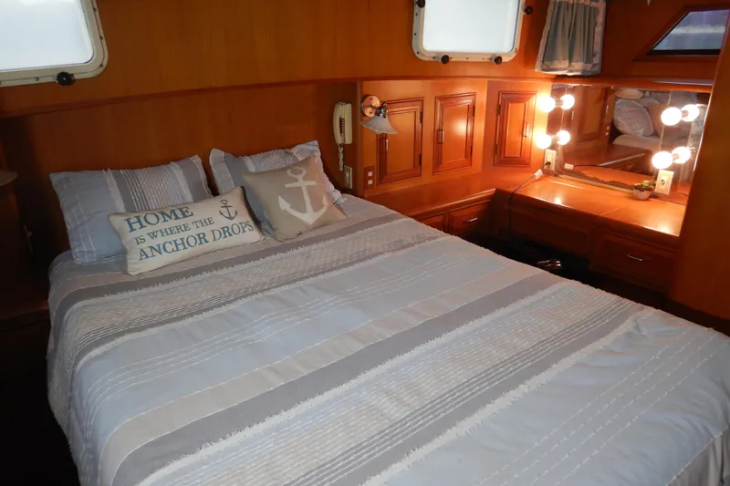 Alaska Sea Duction Yacht Photos Pics Cozy bedroom in 1988 Camargue 48 Cockpit Motor Yacht with nautical decor and vanity.