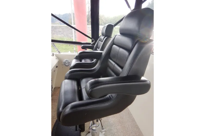 Alaska Sea Duction Yacht Photos Pics Black leather seats in 1988 Camargue 48 Cockpit Motor Yacht cockpit.