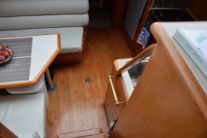 Alaska Sea Duction Yacht Photos Pics Interior of 1988 Camargue 48 Cockpit Motor Yacht with wooden flooring and dining area.