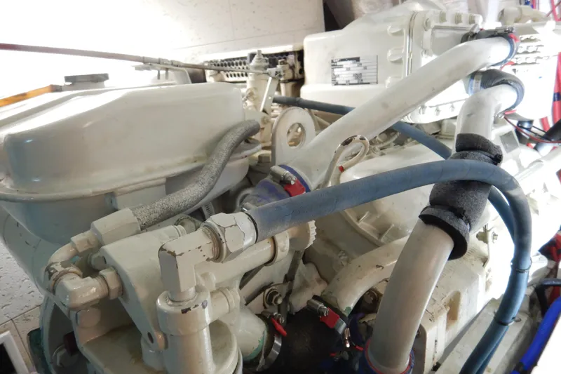 Alaska Sea Duction Yacht Photos Pics Engine compartment of a 1988 Camargue 48 Cockpit Motor Yacht, featuring hoses and components.