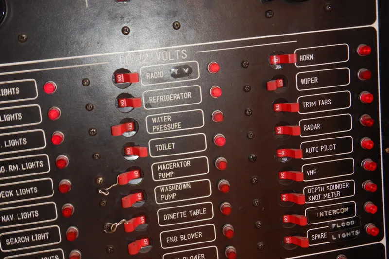 Alaska Sea Duction Yacht Photos Pics Control panel of a 1988 Camargue 48 Cockpit Motor Yacht with labeled switches.