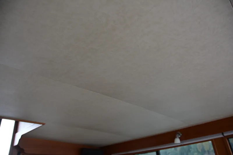 Alaska Sea Duction Yacht Photos Pics Interior ceiling of 1988 Camargue 48 Cockpit Motor Yacht, featuring light fixture and window.