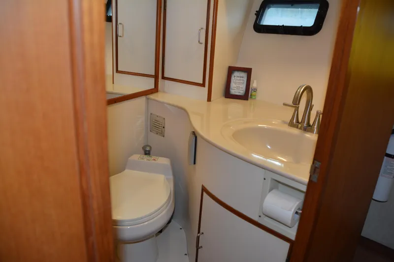 Alaska Sea Duction Yacht Photos Pics 1988 Camargue 48 Cockpit Motor Yacht bathroom with sink, toilet, and mirror.