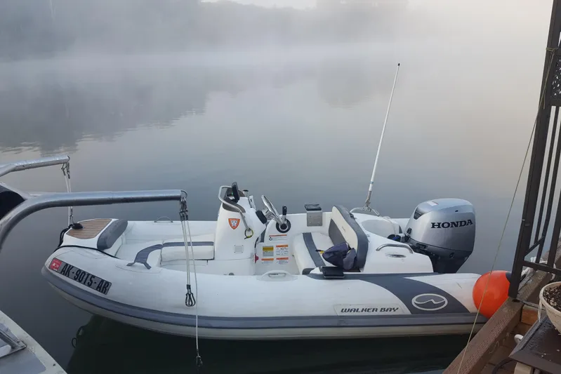 Alaska Sea Duction Yacht Photos Pics Inflatable boat with Honda motor on misty water, near Camargue 48 Cockpit Motor Yacht, 1988.