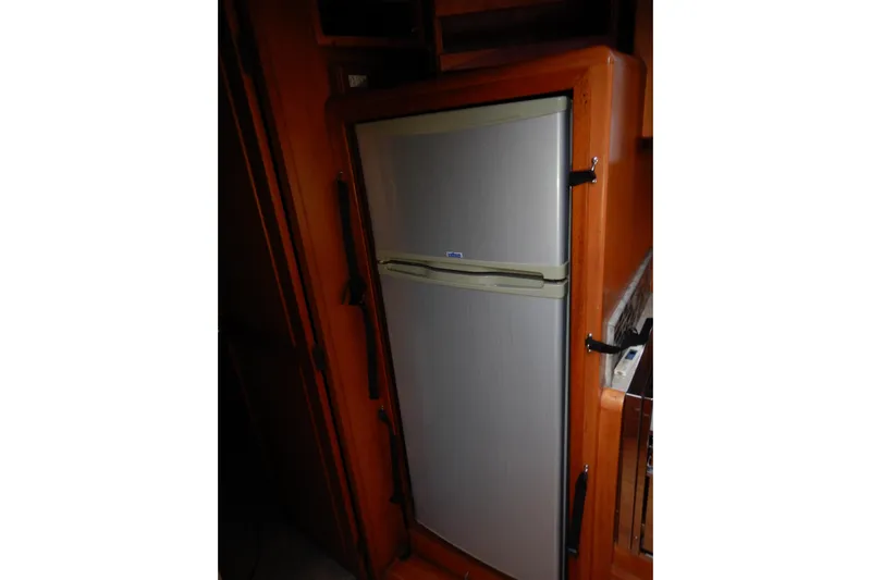 Alaska Sea Duction Yacht Photos Pics Fridge inside 1988 Camargue 48 Cockpit Motor Yacht, wooden interior.