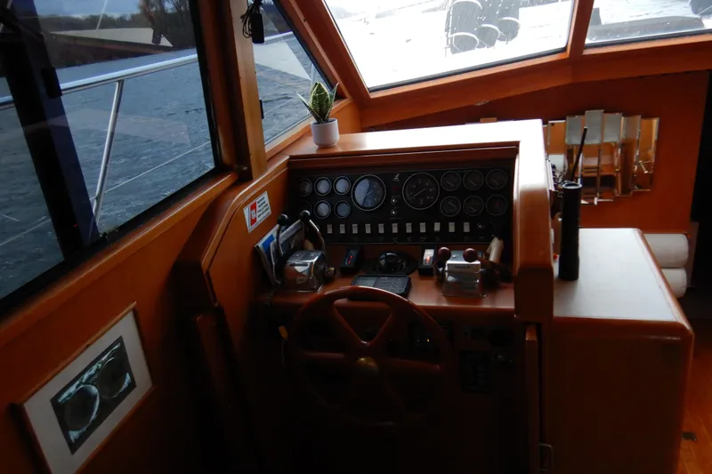 Alaska Sea Duction Yacht Photos Pics 1988 Camargue 48 Cockpit Motor Yacht helm with wooden steering wheel and control panel.