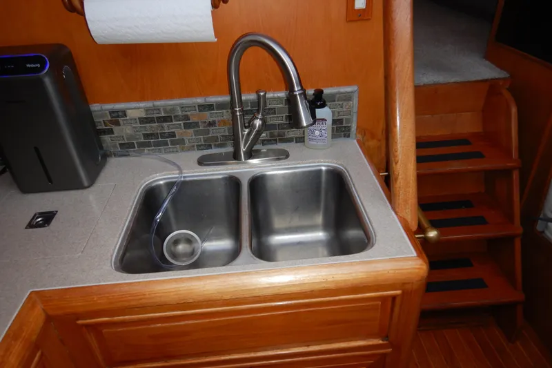 Alaska Sea Duction Yacht Photos Pics 1988 Camargue 48 Cockpit Motor Yacht kitchen sink with dual basins and modern faucet.