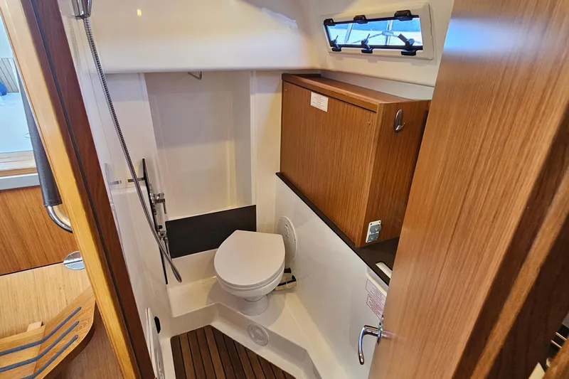 Skal Yacht Photos Pics Bavaria Cruiser 34 2021 yacht bathroom with wooden cabinetry and compact design.