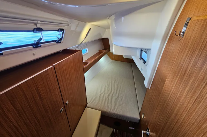 Skal Yacht Photos Pics Interior cabin of 2021 Bavaria Cruiser 34 yacht, featuring wood finish and cozy sleeping area.