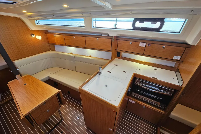 Skal Yacht Photos Pics Interior of 2021 Bavaria Cruiser 34 yacht with modern kitchen and seating area.