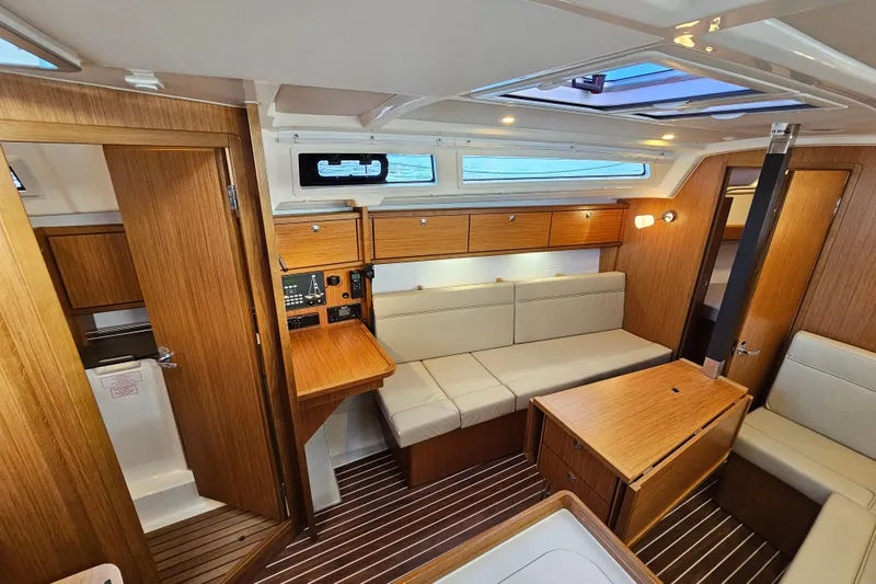 Skal Yacht Photos Pics Interior of 2021 Bavaria Cruiser 34 yacht with wooden finish and cozy seating area.