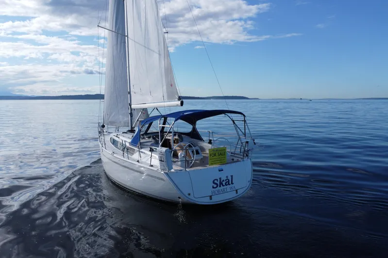 Skal Yacht Photos Pics 2021 Bavaria Cruiser 34 sailboat on calm sea with "For Sale" sign.