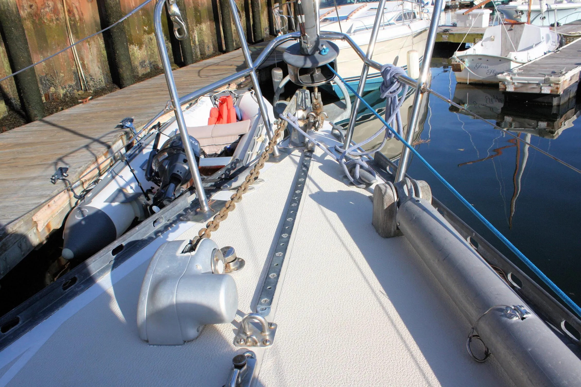1976 Tartan 38 sailboat deck with anchor chain and docked marina view.
