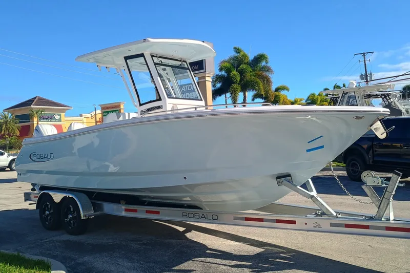 250-118 Yacht Photos Pics 2026 Robalo R250 Center Console boat on trailer, parked outdoors.