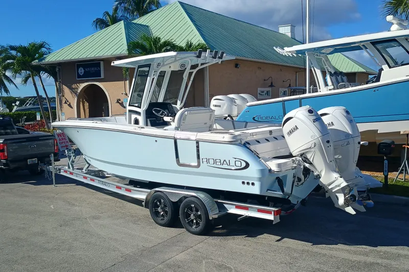 250-118 Yacht Photos Pics 2026 Robalo R250 Center Console boat on trailer, featuring twin Yamaha engines.