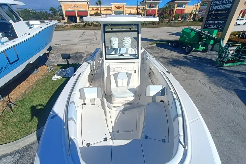 250-118 Yacht Photos Pics 2026 Robalo R250 Center Console boat displayed outdoors at a dealership.