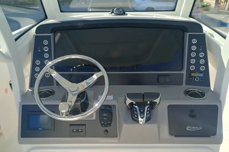 250-118 Yacht Photos Pics 2026 Robalo R250 Center Console dashboard with steering wheel and control panel.