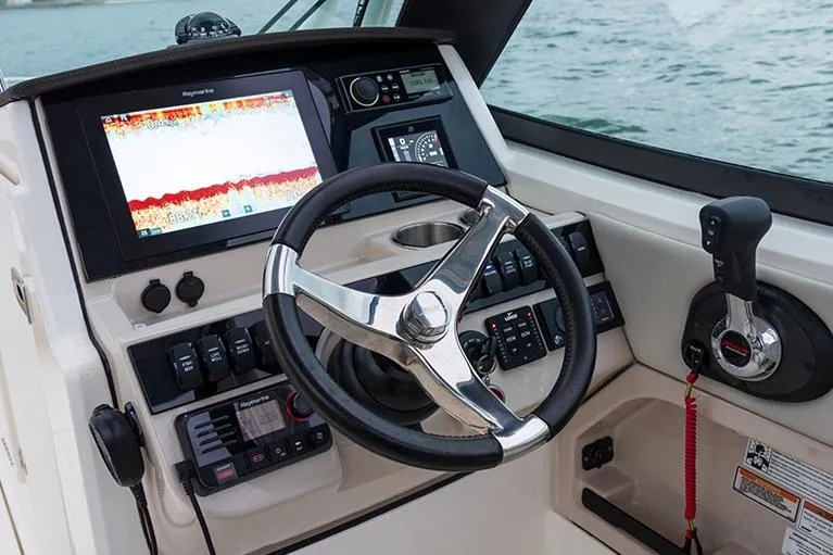 Blue Horizons II Yacht Photos Pics Manufacturer Provided Image: 2023 Boston Whaler 240 Vantage helm with steering wheel, controls, and navigation display.