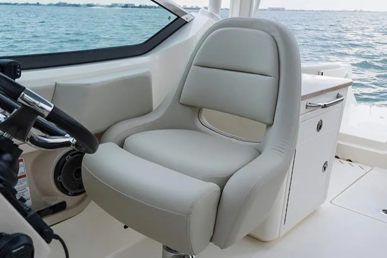 Blue Horizons II Yacht Photos Pics Manufacturer Provided Image: Captain's chair on 2023 Boston Whaler 240 Vantage boat, with ocean view.