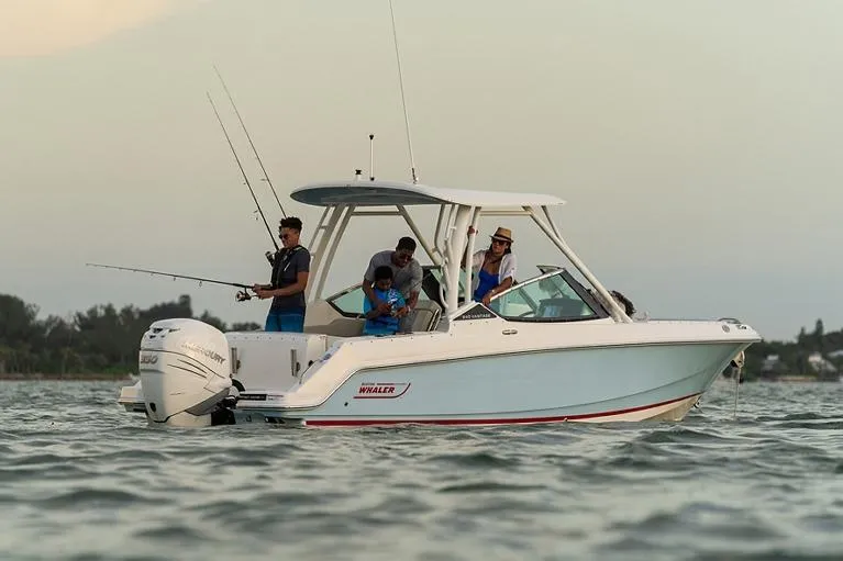 Blue Horizons II Yacht Photos Pics Manufacturer Provided Image: 2023 Boston Whaler 240 Vantage boat with people fishing on calm water.