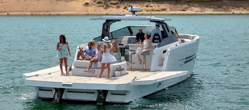  Yacht Photos Pics Luxury OKEAN 57 yacht cruising with passengers enjoying the sun, 2023 model.