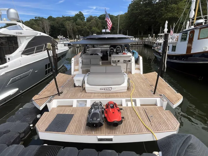  Yacht Photos Pics 2023 OKEAN 57 yacht docked, featuring spacious deck and modern design.