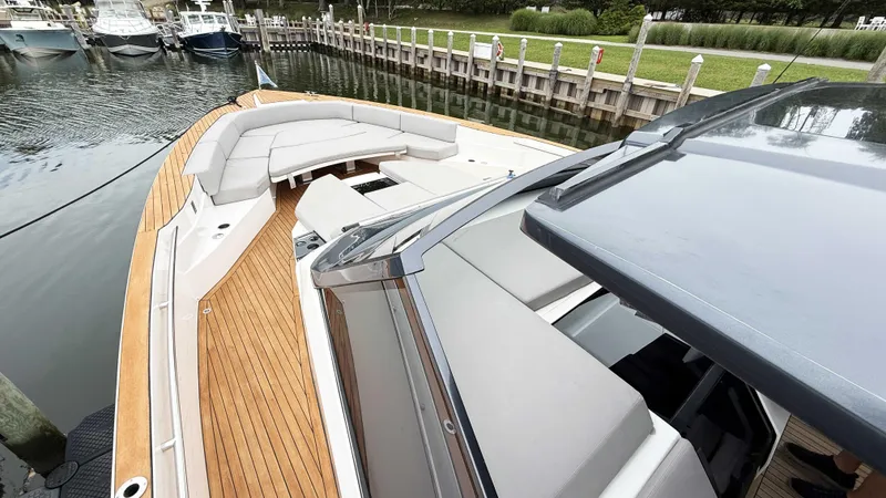  Yacht Photos Pics 2023 OKEAN 57 yacht with sleek design, spacious deck, and luxurious seating at a marina.