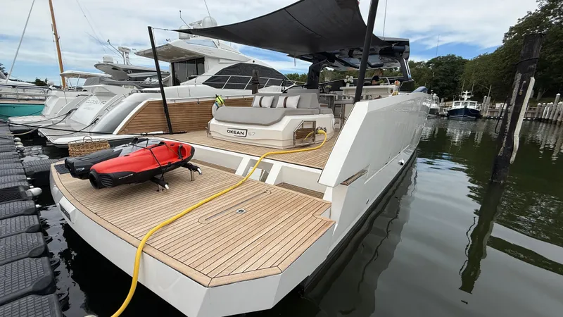  Yacht Photos Pics Luxury 2023 OKEAN 57 yacht docked, featuring sleek design and spacious deck.
