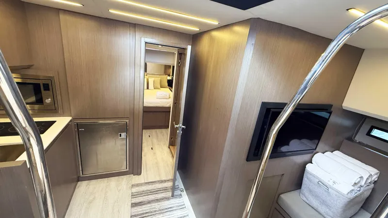  Yacht Photos Pics Luxurious interior of 2023 OKEAN 57 yacht featuring modern kitchen and cozy bedroom.