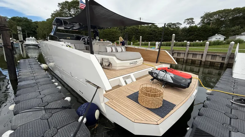  Yacht Photos Pics Luxury 2023 OKEAN 57 yacht docked, featuring sleek design and spacious deck.
