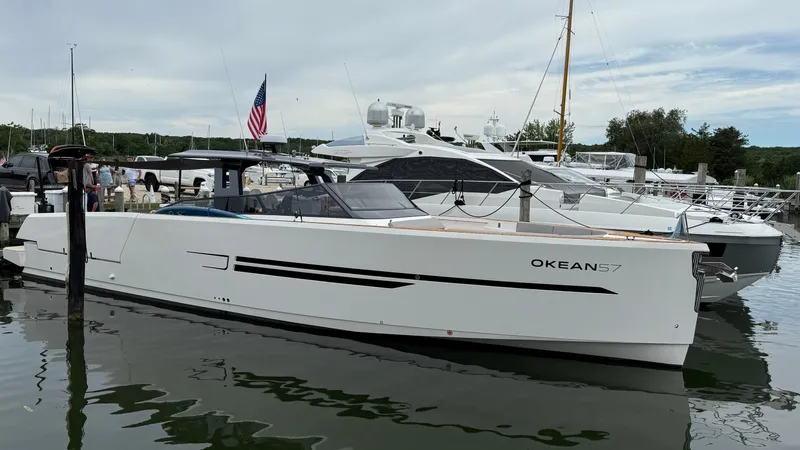  Yacht Photos Pics 2023 OKEAN 57 yacht docked at marina with American flag in background.