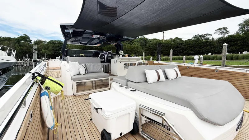  Yacht Photos Pics Luxurious 2023 OKEAN 57 yacht deck with seating, canopy, and modern amenities.