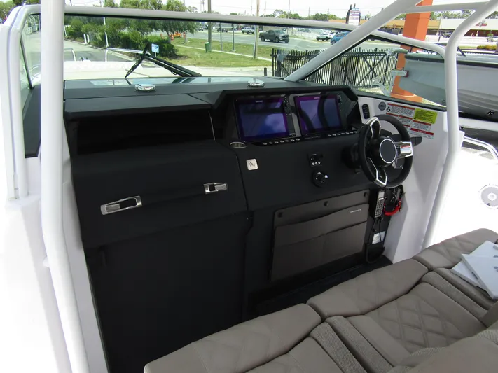  Yacht Photos Pics 2024 Axopar 37 Sun Top dashboard with modern controls and navigation screens.