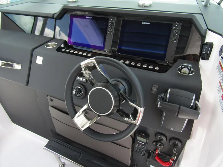  Yacht Photos Pics 2024 Axopar 37 Sun Top helm with dual Simrad displays and modern steering wheel.
