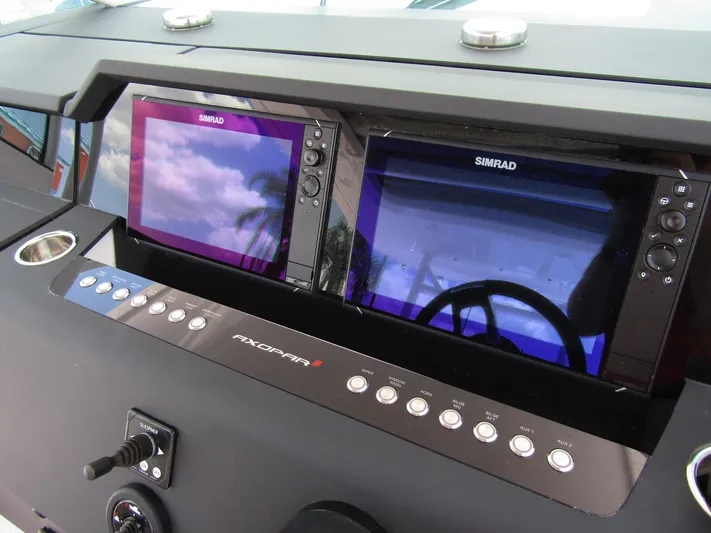  Yacht Photos Pics 2024 Axopar 37 Sun Top dashboard with dual Simrad displays and control panel.