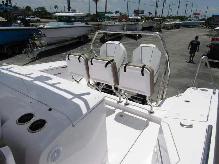  Yacht Photos Pics 2024 Axopar 37 Sun Top boat with sleek seating and modern design in a marina setting.