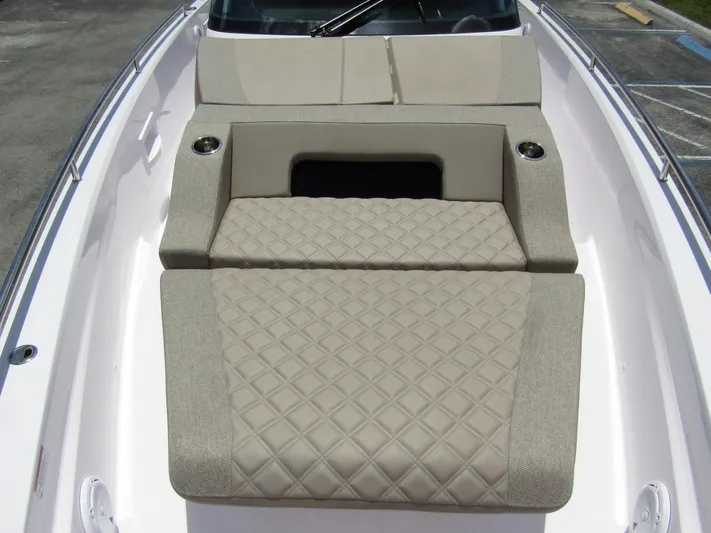  Yacht Photos Pics 2024 Axopar 37 Sun Top boat with beige cushioned seating and sleek design.