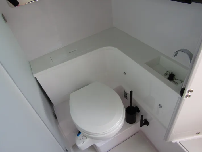  Yacht Photos Pics 2024 Axopar 37 Sun Top boat bathroom with modern fixtures and compact design.