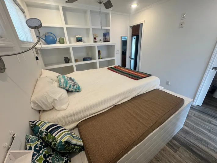  Yacht Photos Pics Interior of Harbor Cottage Cozy Cottage Tiny Boat, bedroom with shelving.