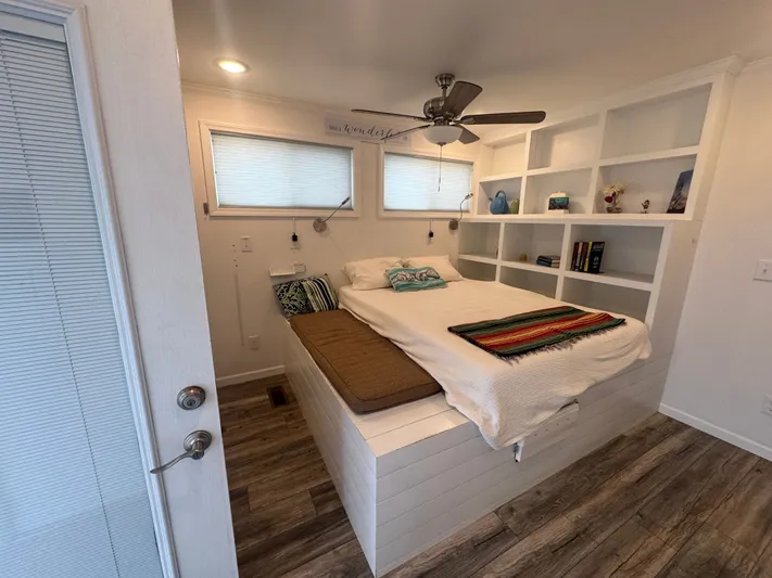  Yacht Photos Pics Interior of 2019 Harbor Cottage Tiny Boat with bed and shelves.