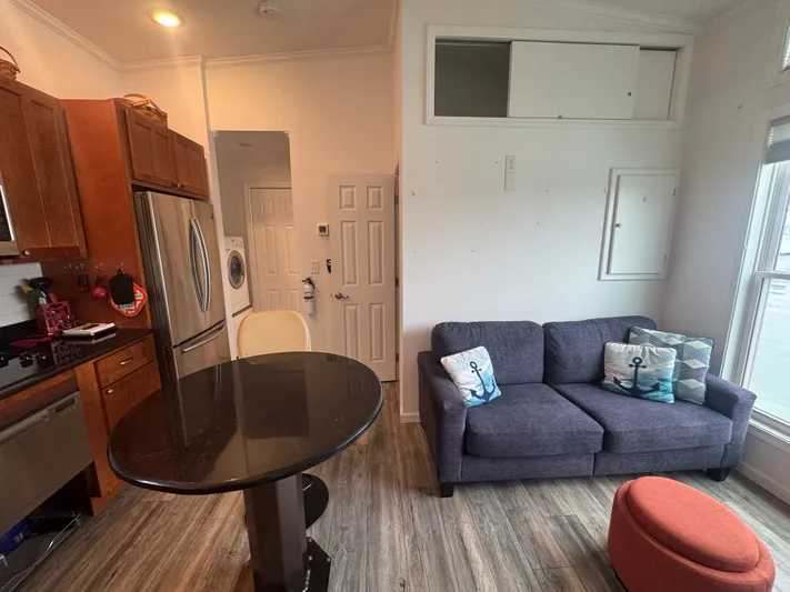  Yacht Photos Pics Interior of 2019 Harbor Cottage Tiny Boat with kitchen and living area.